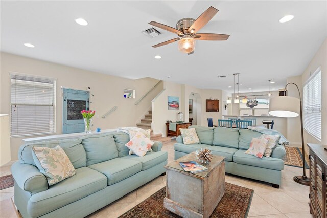 living area with stairway, light tile patterned floors, visible vents, and recessed lighting