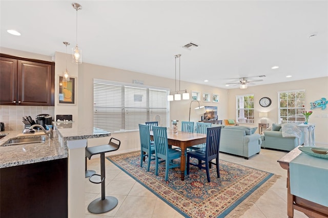 dining space featuring ceiling fan, light tile patterned flooring, recessed lighting, visible vents, and baseboards