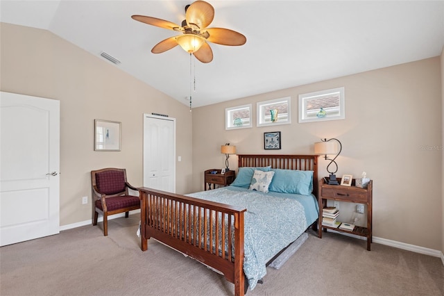 bedroom featuring baseboards, visible vents, vaulted ceiling, and light colored carpet