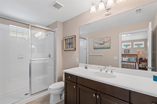 bathroom featuring toilet, a stall shower, and visible vents