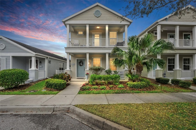 view of front of property with a balcony and a porch