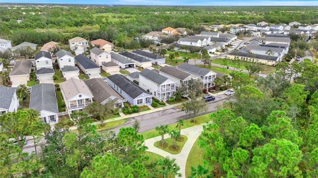 birds eye view of property featuring a residential view and a wooded view