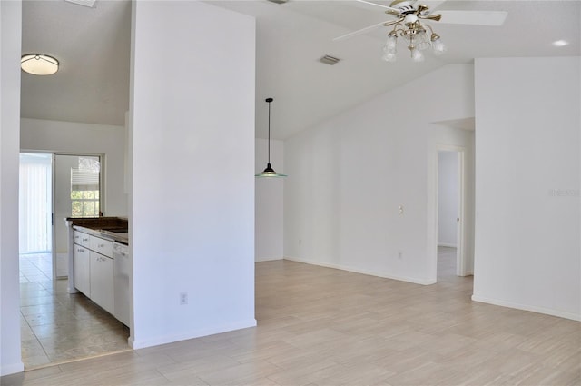 interior space featuring light wood-style flooring, visible vents, vaulted ceiling, and a ceiling fan