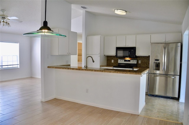 kitchen featuring appliances with stainless steel finishes, visible vents, white cabinets, and a peninsula