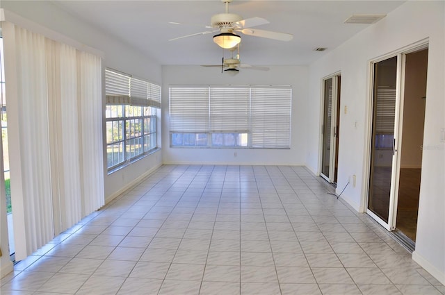 unfurnished sunroom with ceiling fan and visible vents