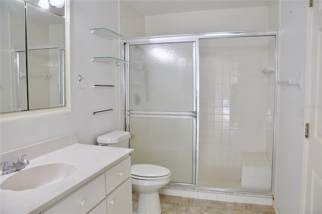 full bathroom with toilet, a stall shower, and vanity