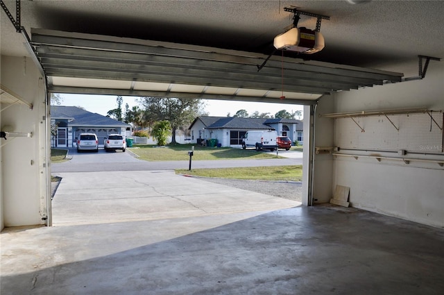 garage featuring a residential view and a garage door opener