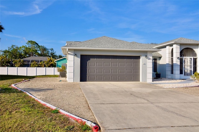 view of front of home featuring a garage, fence, driveway, roof with shingles, and stucco siding