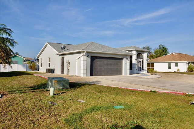 view of front of home featuring central AC unit, an attached garage, concrete driveway, stucco siding, and a front yard