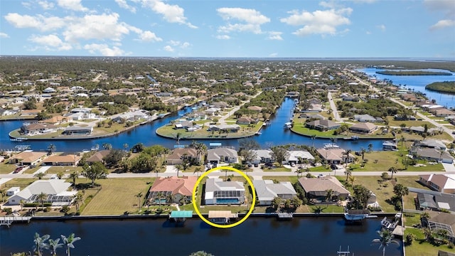 drone / aerial view featuring a water view and a residential view