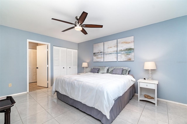 bedroom featuring baseboards, a closet, and light tile patterned flooring