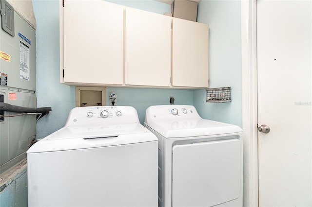 laundry area featuring independent washer and dryer and cabinet space