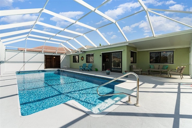 outdoor pool featuring glass enclosure, a patio, and outdoor lounge area