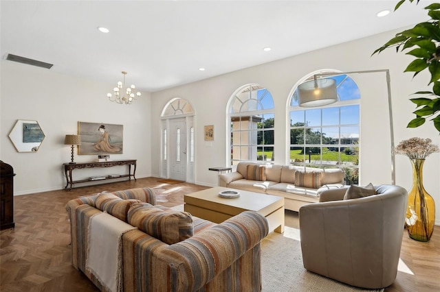 living room with an inviting chandelier, baseboards, visible vents, and recessed lighting