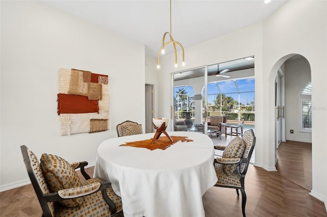 dining area featuring a sunroom and baseboards