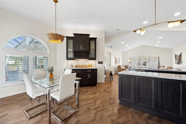 dining space featuring lofted ceiling, baseboards, a dry bar, and recessed lighting