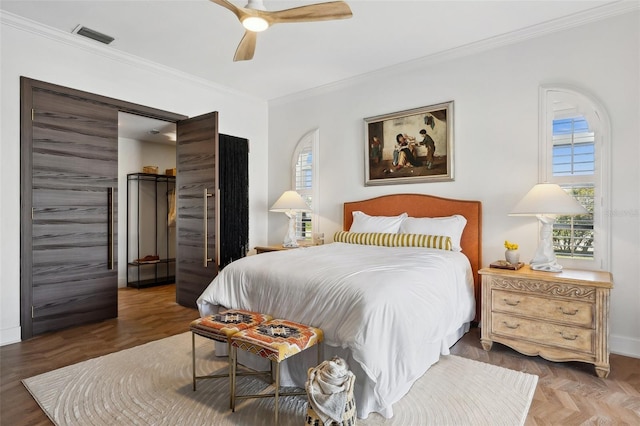 bedroom featuring visible vents, crown molding, and ceiling fan