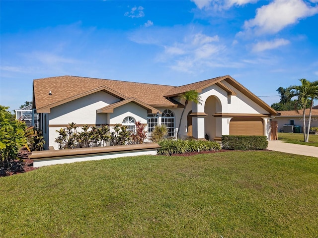 view of front of property with driveway, a front lawn, an attached garage, and stucco siding