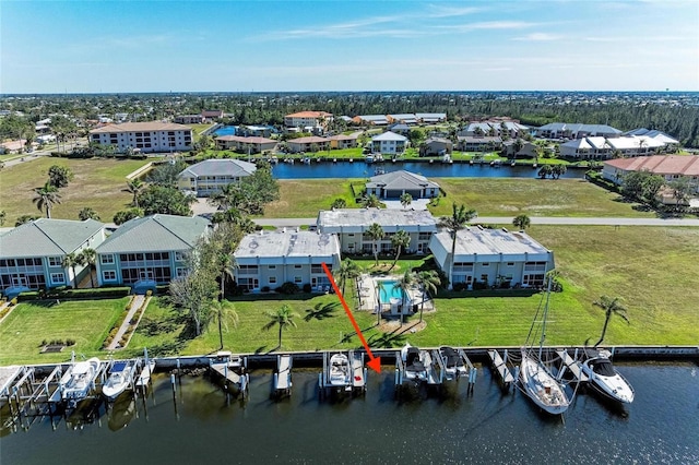 drone / aerial view with a water view and a residential view