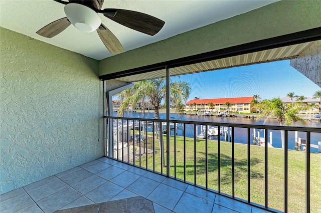 balcony with a water view and ceiling fan