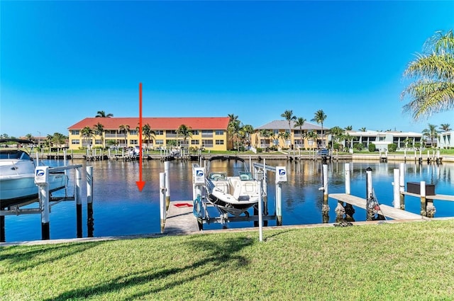 dock area with a residential view, a water view, a lawn, and boat lift