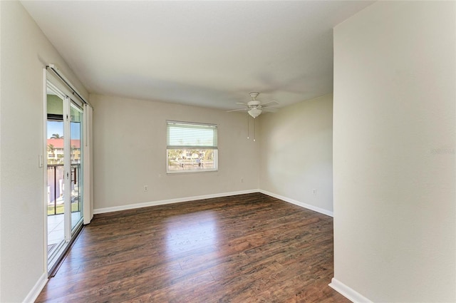 spare room featuring a ceiling fan, baseboards, and wood finished floors