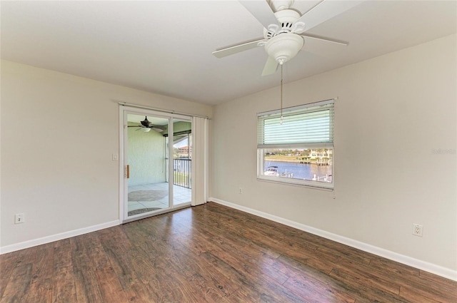 spare room with ceiling fan, wood finished floors, and baseboards