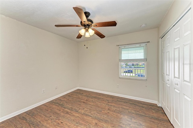 unfurnished bedroom with a closet, ceiling fan, baseboards, and wood finished floors