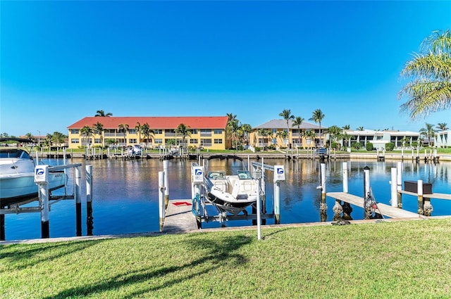 view of dock featuring a residential view, a water view, a lawn, and boat lift