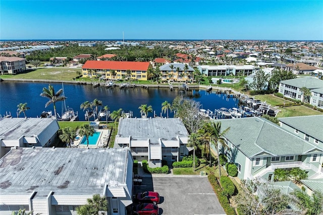 drone / aerial view featuring a residential view and a water view