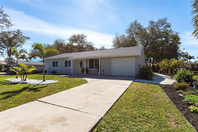 single story home with concrete driveway, a front yard, an attached garage, and stucco siding