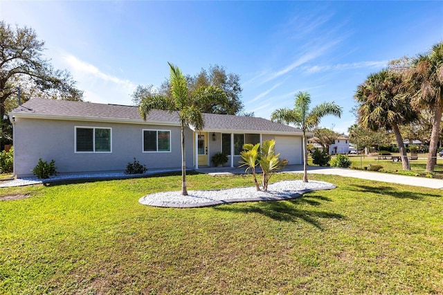 single story home featuring a garage, driveway, a front yard, and stucco siding