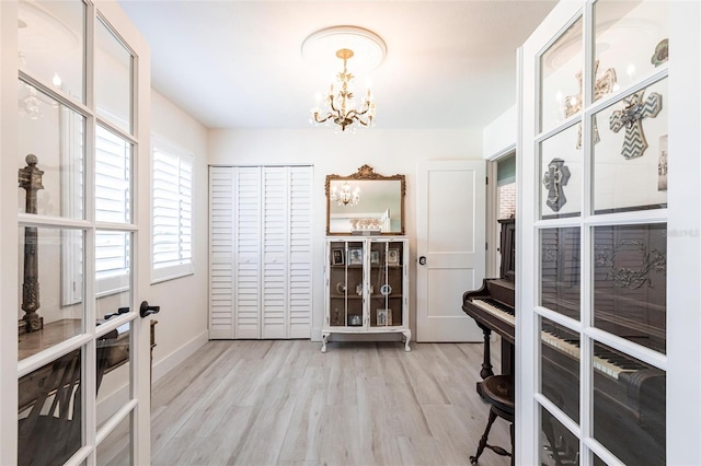 interior space featuring light wood-style floors and a notable chandelier