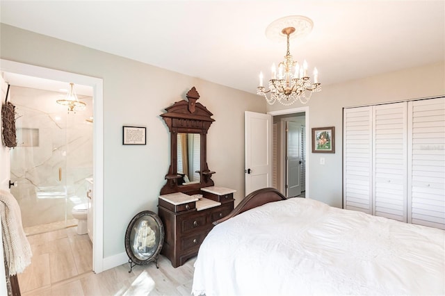 bedroom featuring baseboards, light wood-style flooring, ensuite bathroom, a notable chandelier, and a closet