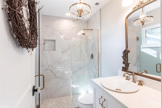 full bath featuring a marble finish shower, visible vents, and a chandelier