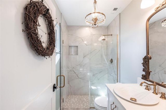 bathroom featuring a notable chandelier, a marble finish shower, visible vents, toilet, and vanity