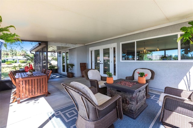 view of patio / terrace featuring french doors and an outdoor living space with a fire pit