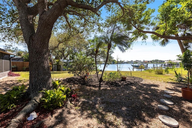 view of yard featuring a water view and fence