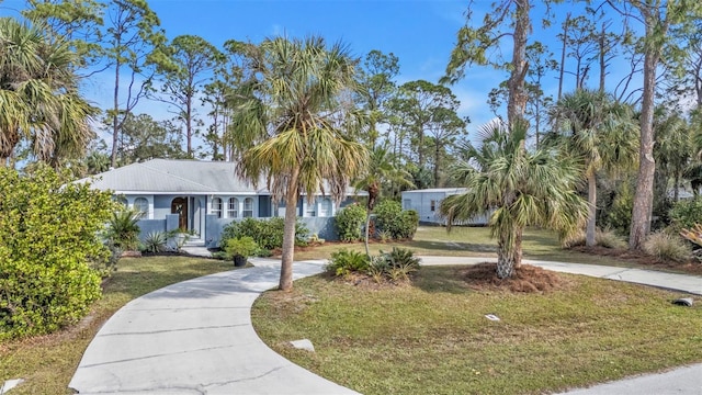 view of front of home featuring concrete driveway and a front lawn