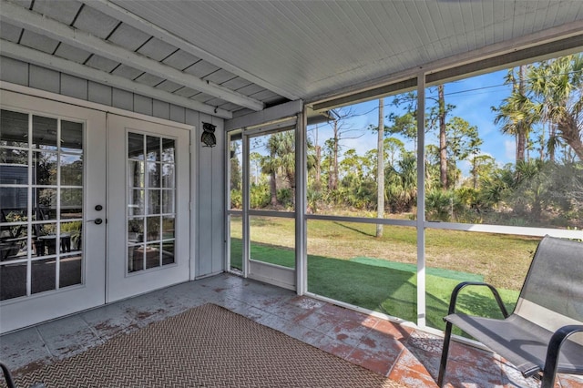 unfurnished sunroom with french doors and beamed ceiling