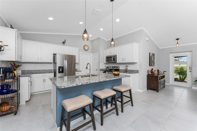 16265 Juarez Cir, Punta Gorda, FL 33955 - kitchen with decorative backsplash, visible vents, crown molding, a sink, and stainless steel appliances