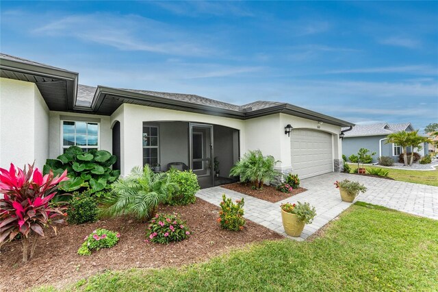 16265 Juarez Cir, Punta Gorda, FL 33955 - view of front of home featuring decorative driveway, a garage, and stucco siding