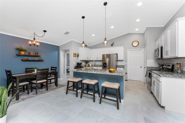 16265 Juarez Cir, Punta Gorda, FL 33955 - kitchen featuring ornamental molding, backsplash, stainless steel appliances, and visible vents