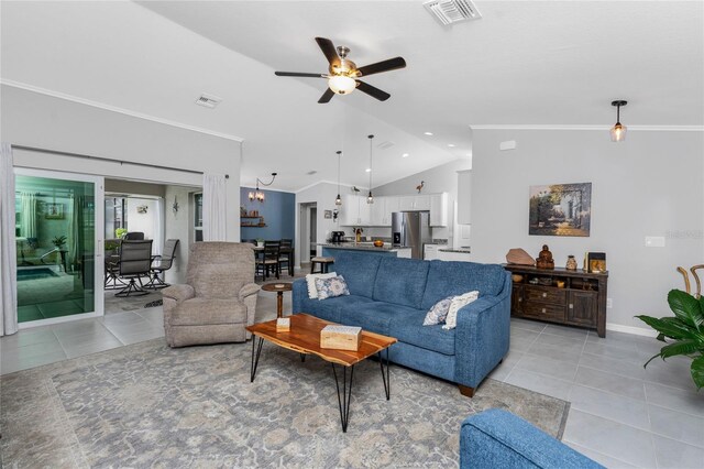 16265 Juarez Cir, Punta Gorda, FL 33955 - living room with visible vents, a ceiling fan, light tile patterned floors, and vaulted ceiling