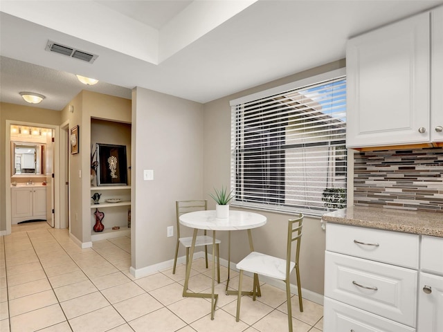 dining area featuring visible vents, baseboards, and light tile patterned floors