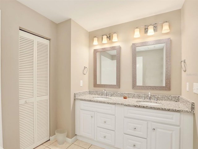 full bath featuring a sink, double vanity, and a closet