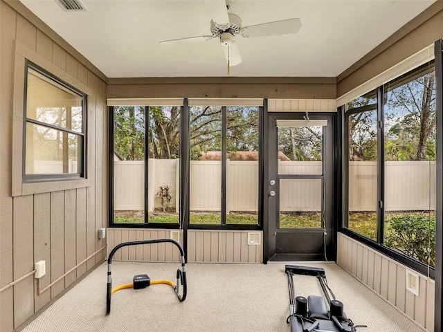 sunroom with a ceiling fan and a wealth of natural light