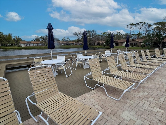 exterior space with a water view and outdoor dining area