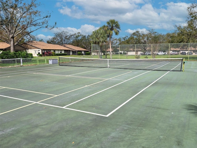 view of sport court featuring a residential view and fence