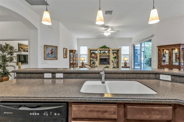 kitchen featuring black dishwasher, visible vents, a sink, and open floor plan